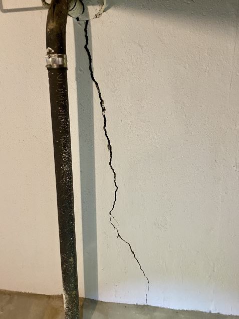 Wall crack indicating need for foundation repair services